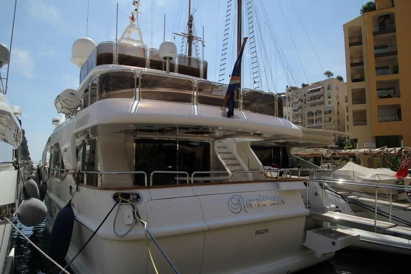a white boat in a harbor aboard RENAISSANCE Yacht for Sale