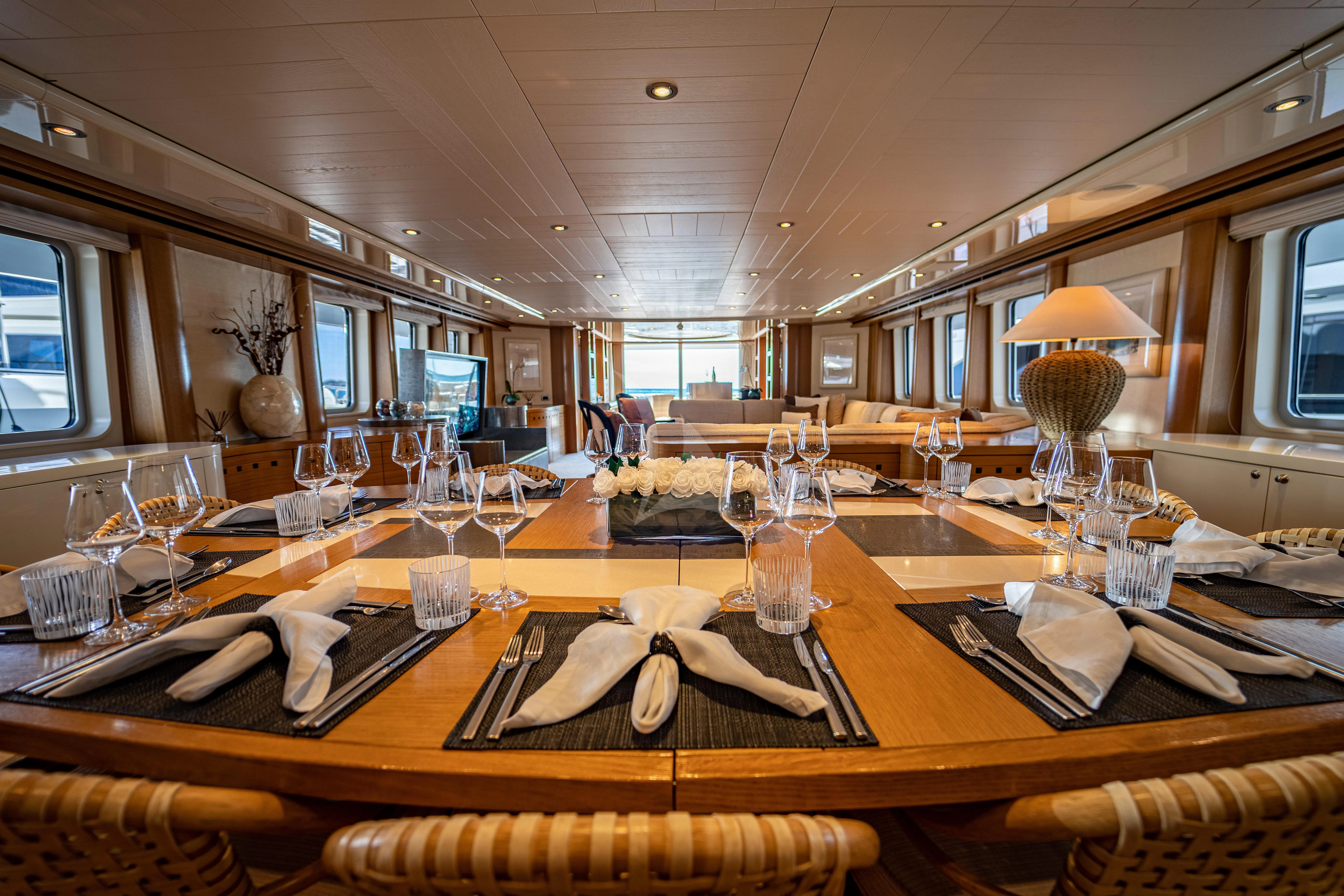 a dining room with a wood table aboard KIJO Yacht for Sale