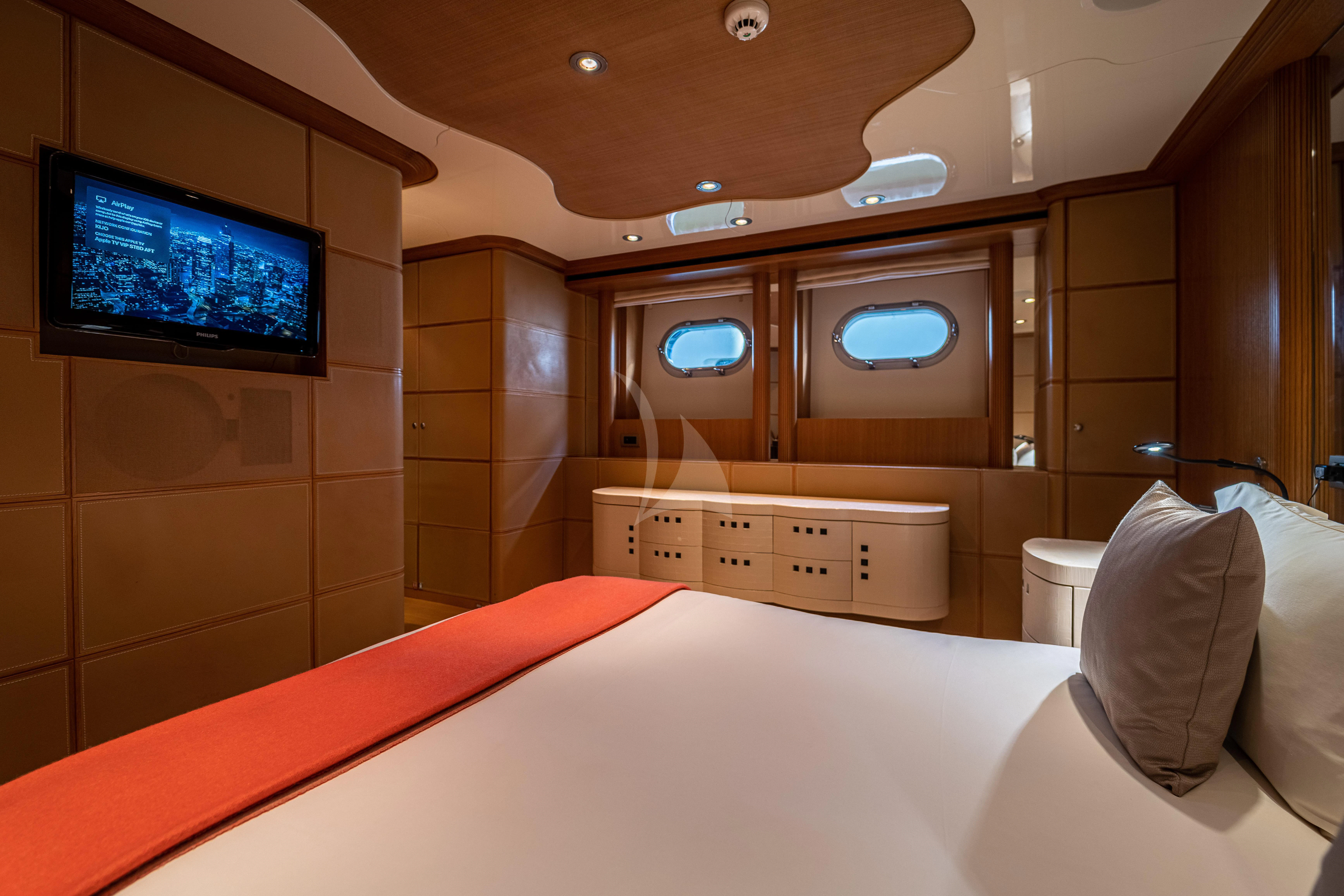 a room with a bed and a tv on the wall aboard KIJO Yacht for Sale