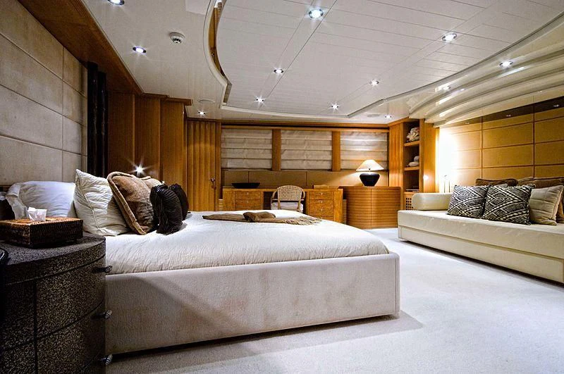 a large bedroom with a bed and a couch aboard KIJO Yacht for Sale