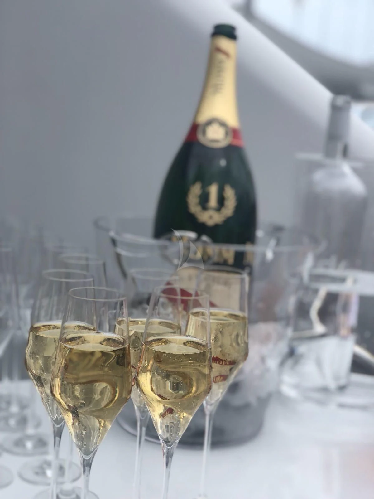a bottle of champagne and glasses aboard KIJO Yacht for Sale