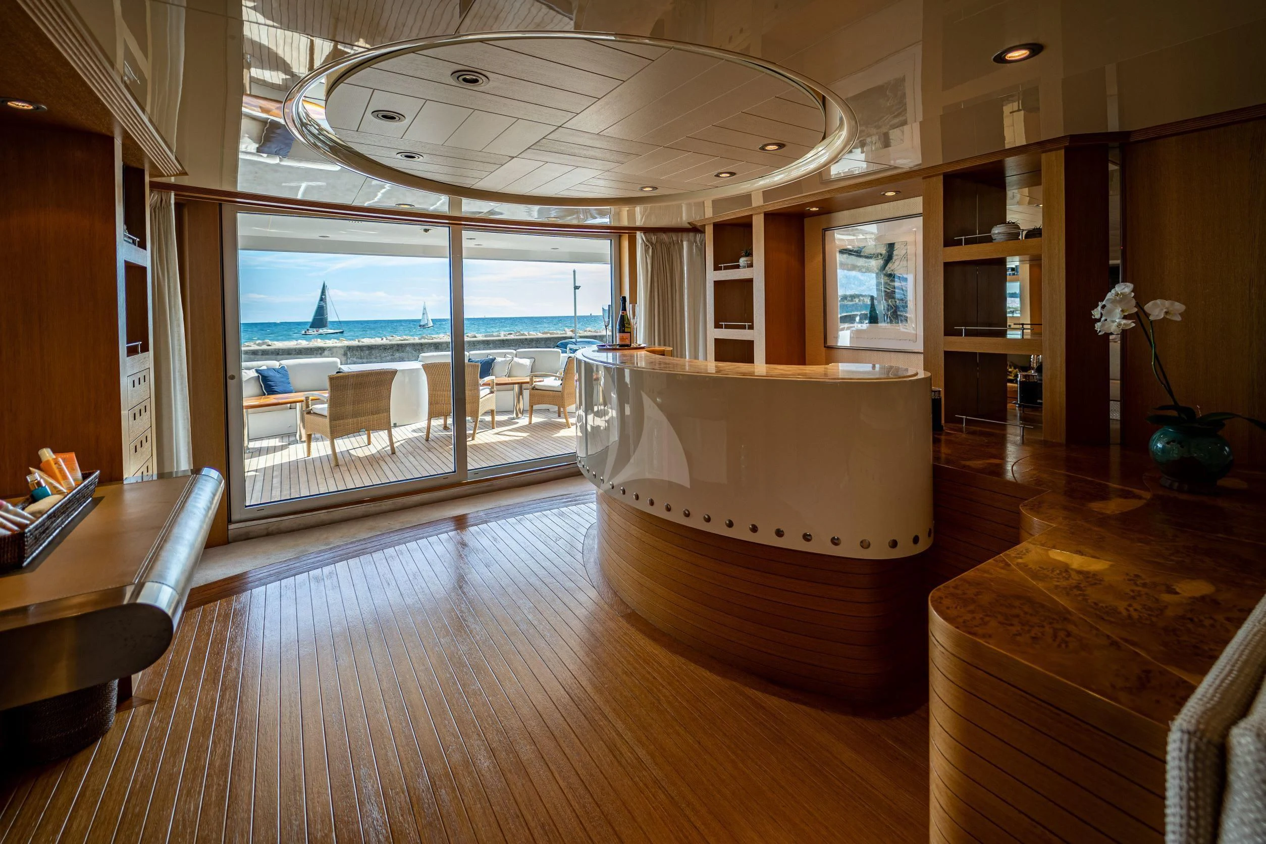 a room with a wood floor and a large window with a view of the ocean aboard KIJO Yacht for Sale