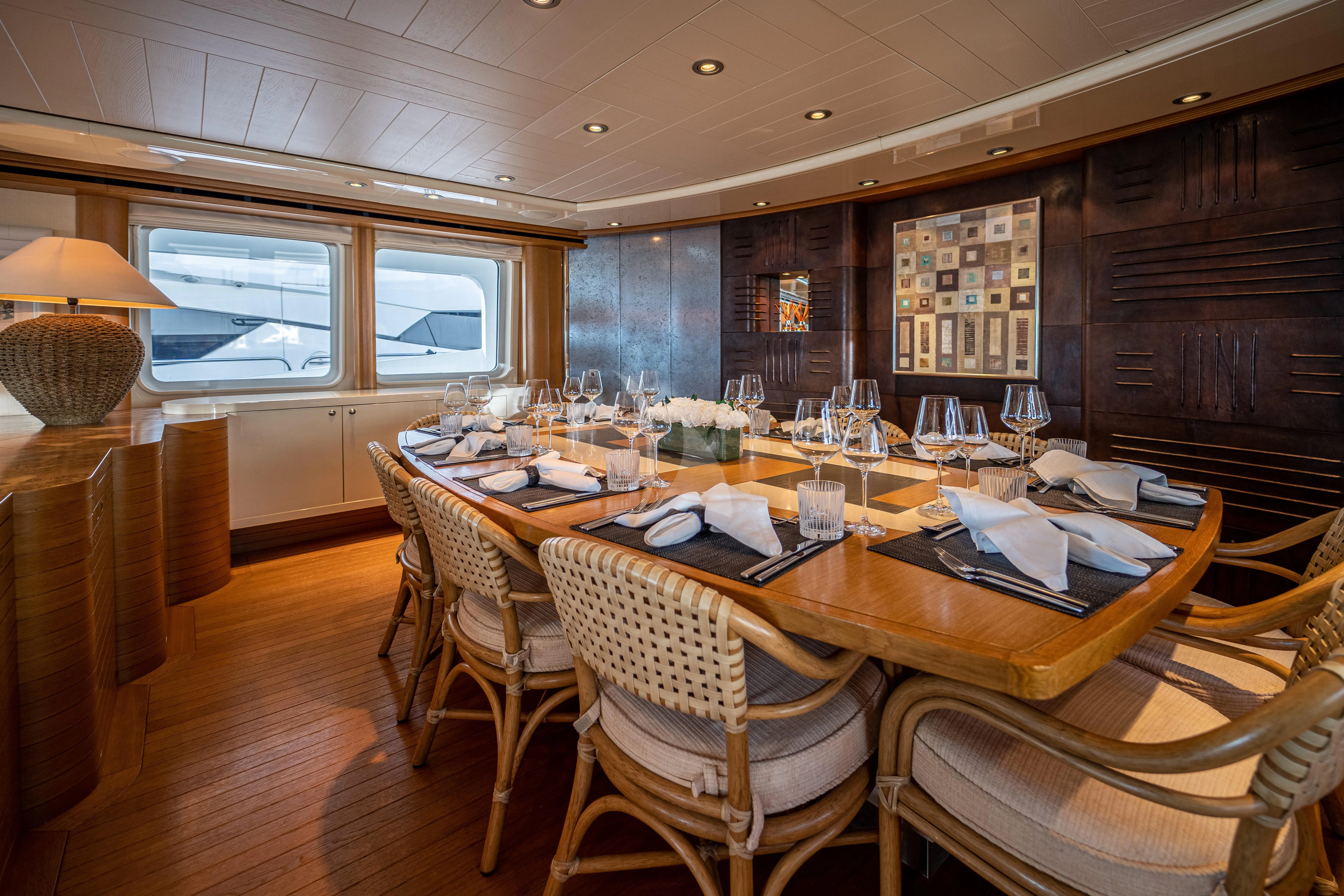 a dining room with a table and chairs aboard KIJO Yacht for Sale