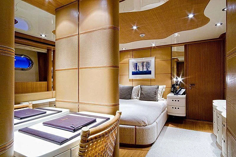 a room with a bed and a table aboard KIJO Yacht for Sale