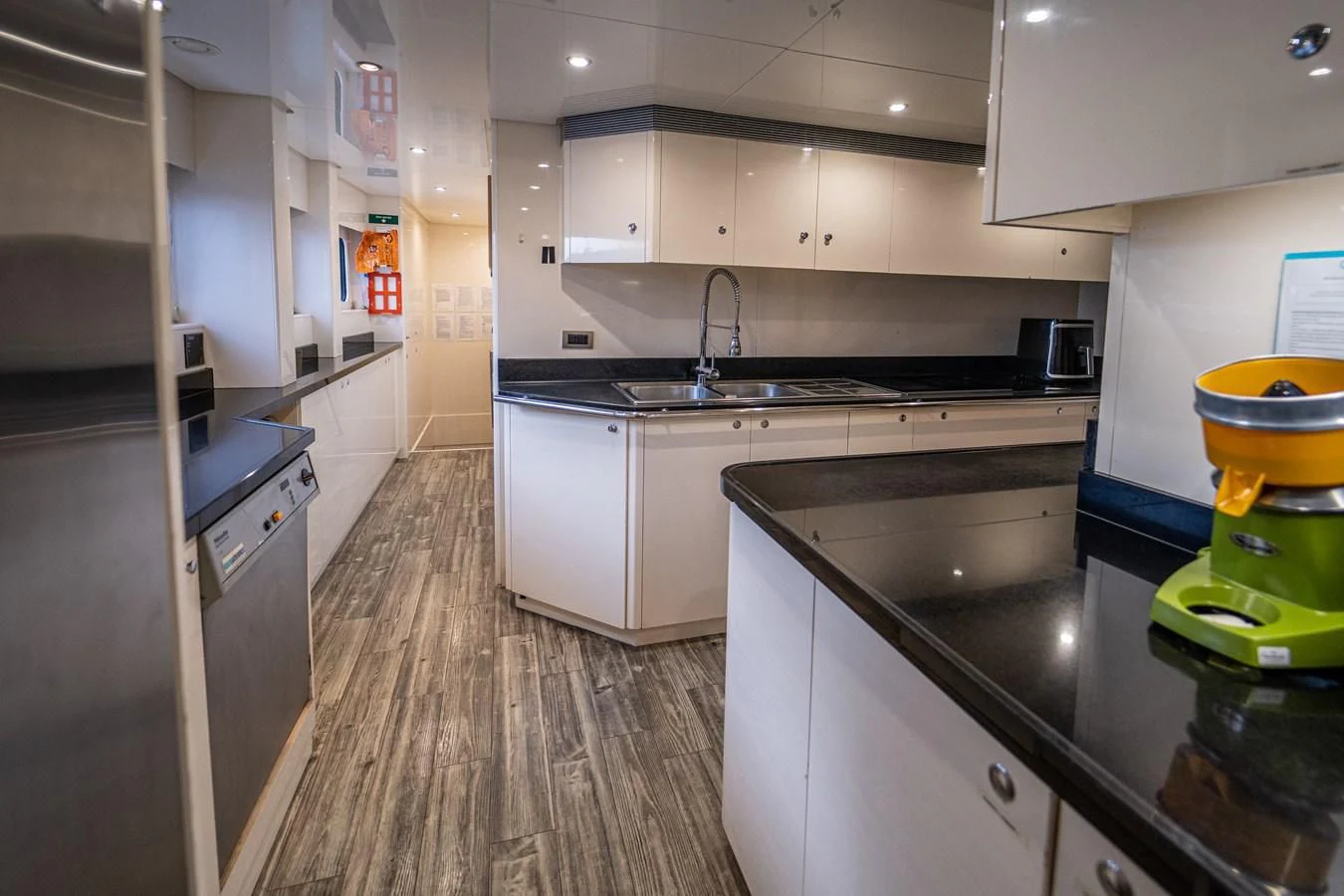 a kitchen with a wood floor aboard KIJO Yacht for Sale