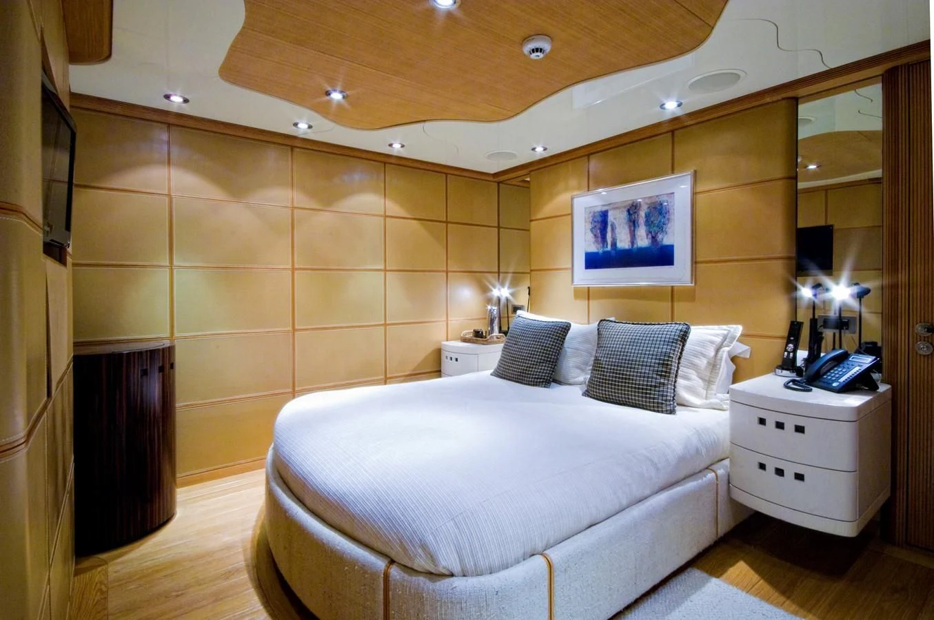 a bedroom with a bed and a mirror aboard KIJO Yacht for Sale