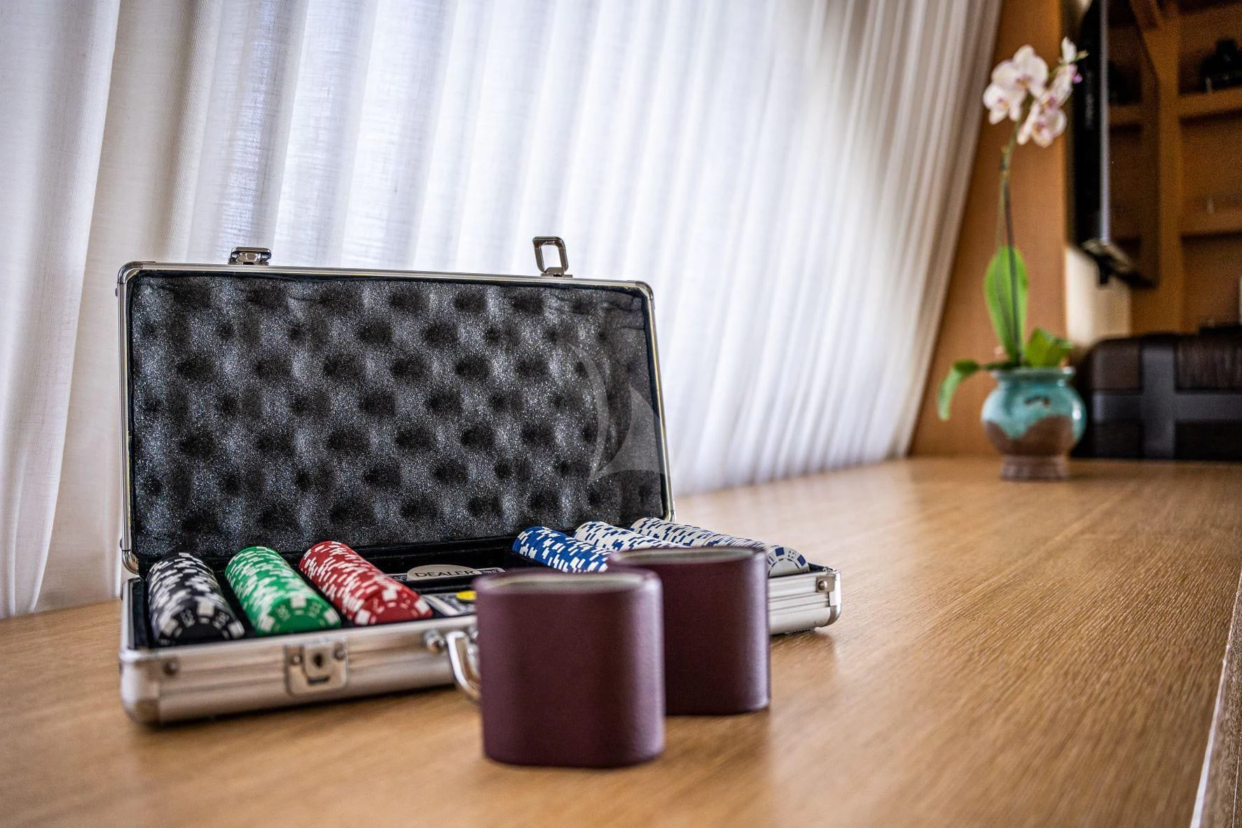 a black and grey suitcase on a table with a white curtain aboard KIJO Yacht for Sale