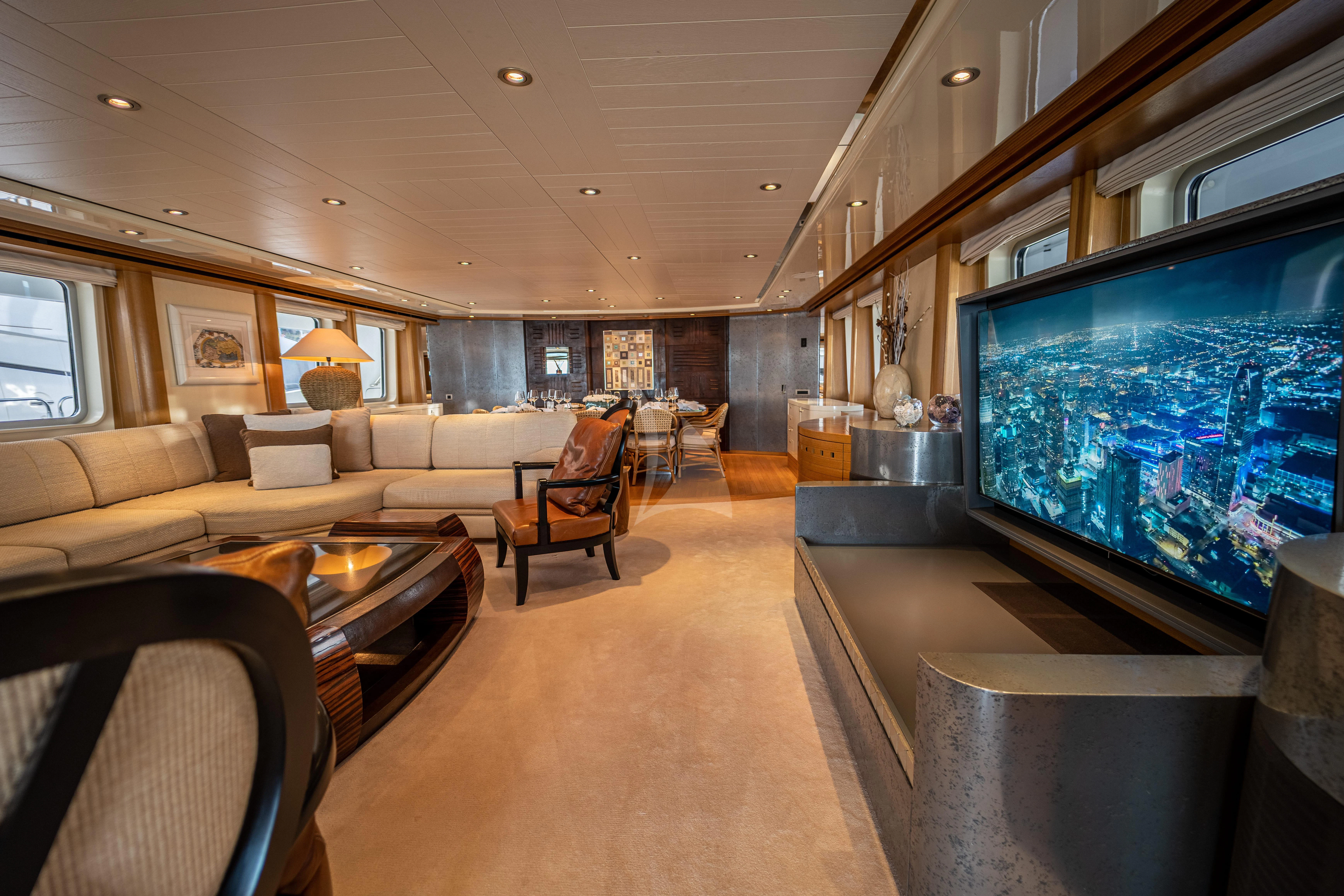 a living room with a large screen aboard KIJO Yacht for Sale