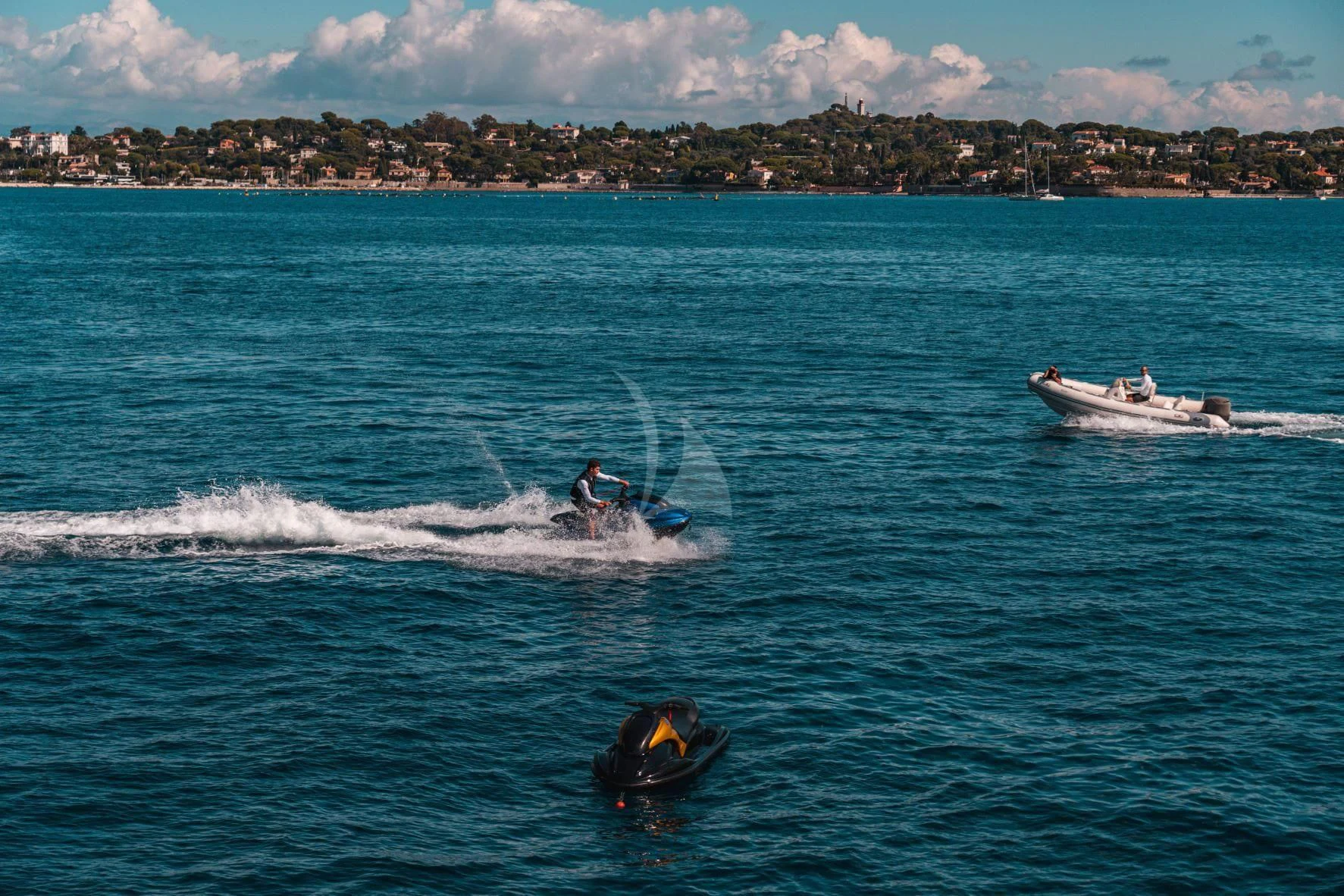a group of people on jet skis in the water aboard KIJO Yacht for Sale