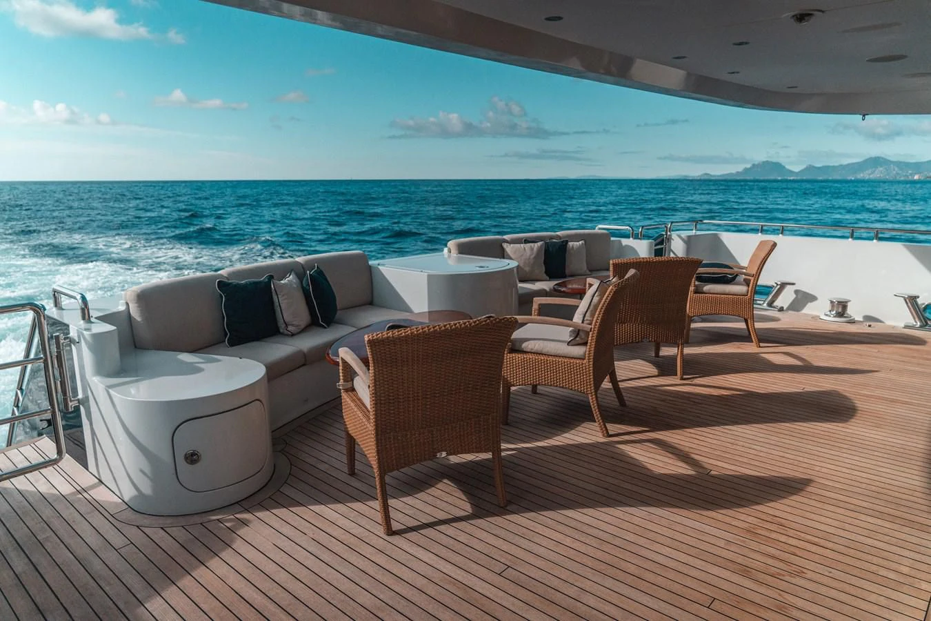 a deck with chairs and a large body of water in the background aboard KIJO Yacht for Sale