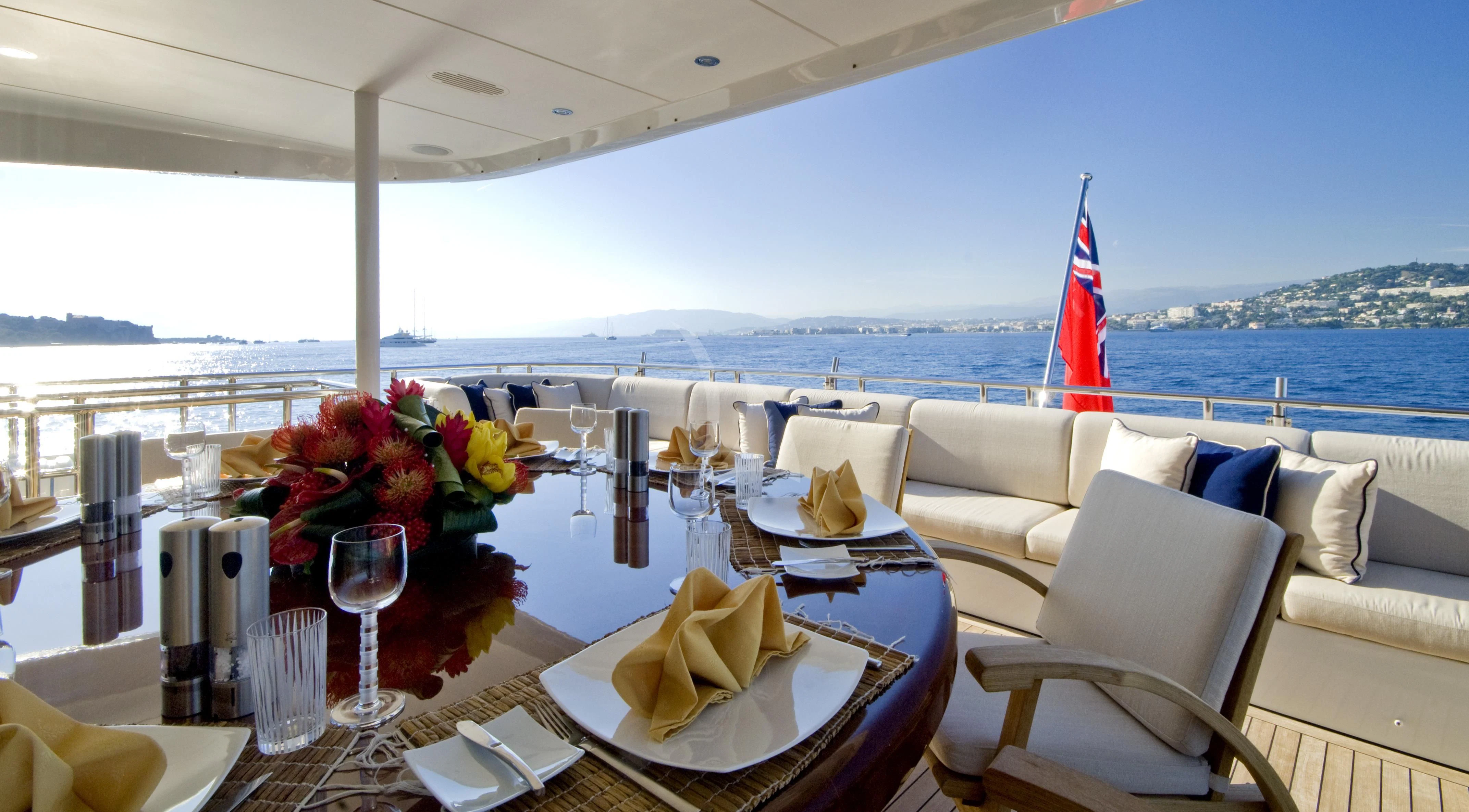 a table with a flag and wine glasses on it aboard KIJO Yacht for Sale
