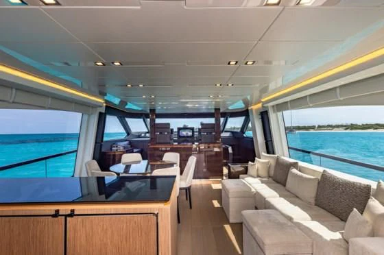 inside of a vehicle with a couch and a table and chairs aboard INCENTIVIZED Yacht for Sale