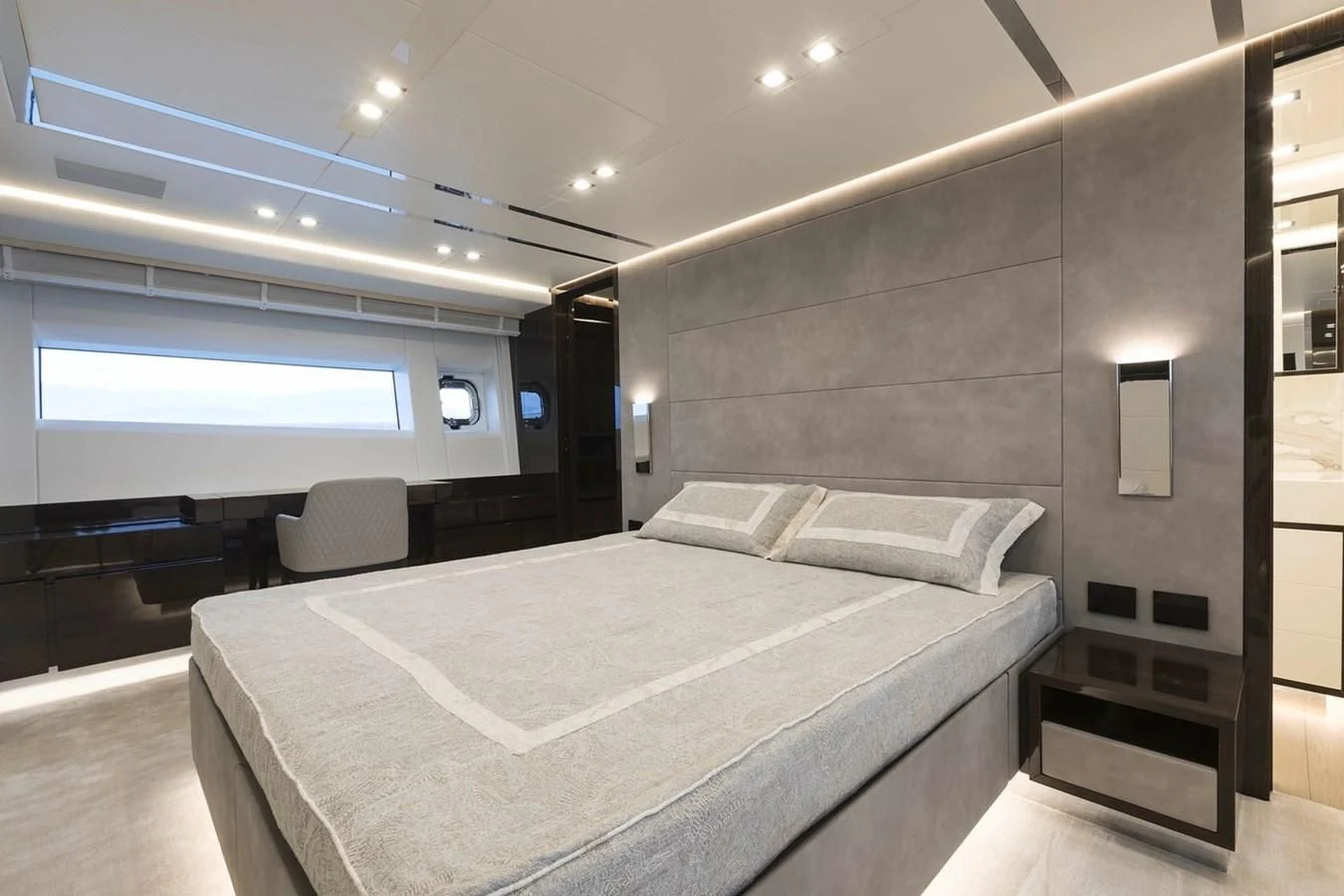 a large room with a bed and a chair aboard INCENTIVIZED Yacht for Sale
