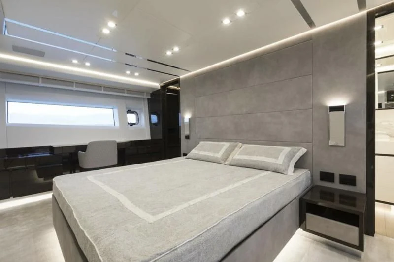a room with a bed and a chair aboard INCENTIVIZED Yacht for Sale
