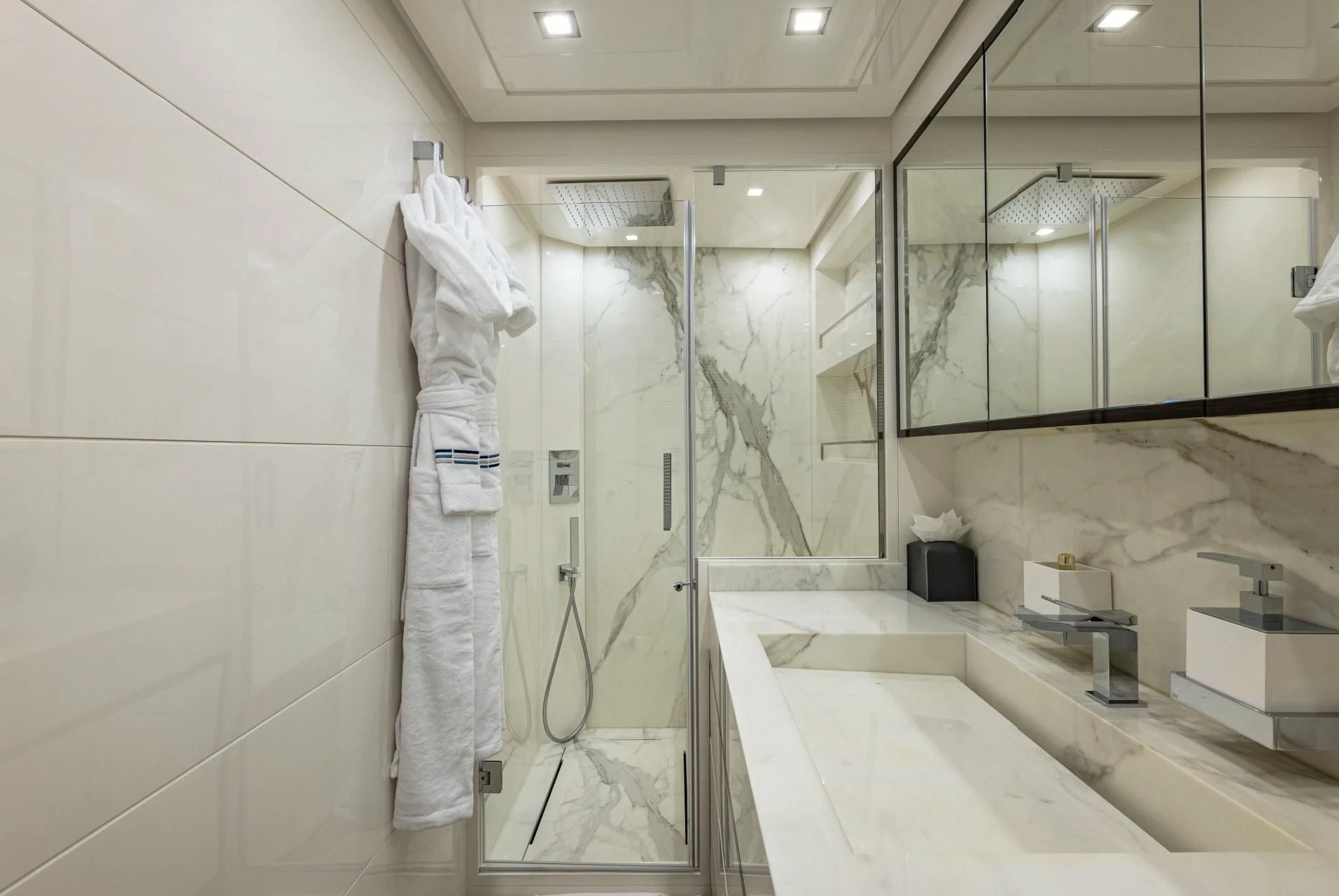 a bathroom with a robe on the wall aboard INCENTIVIZED Yacht for Sale
