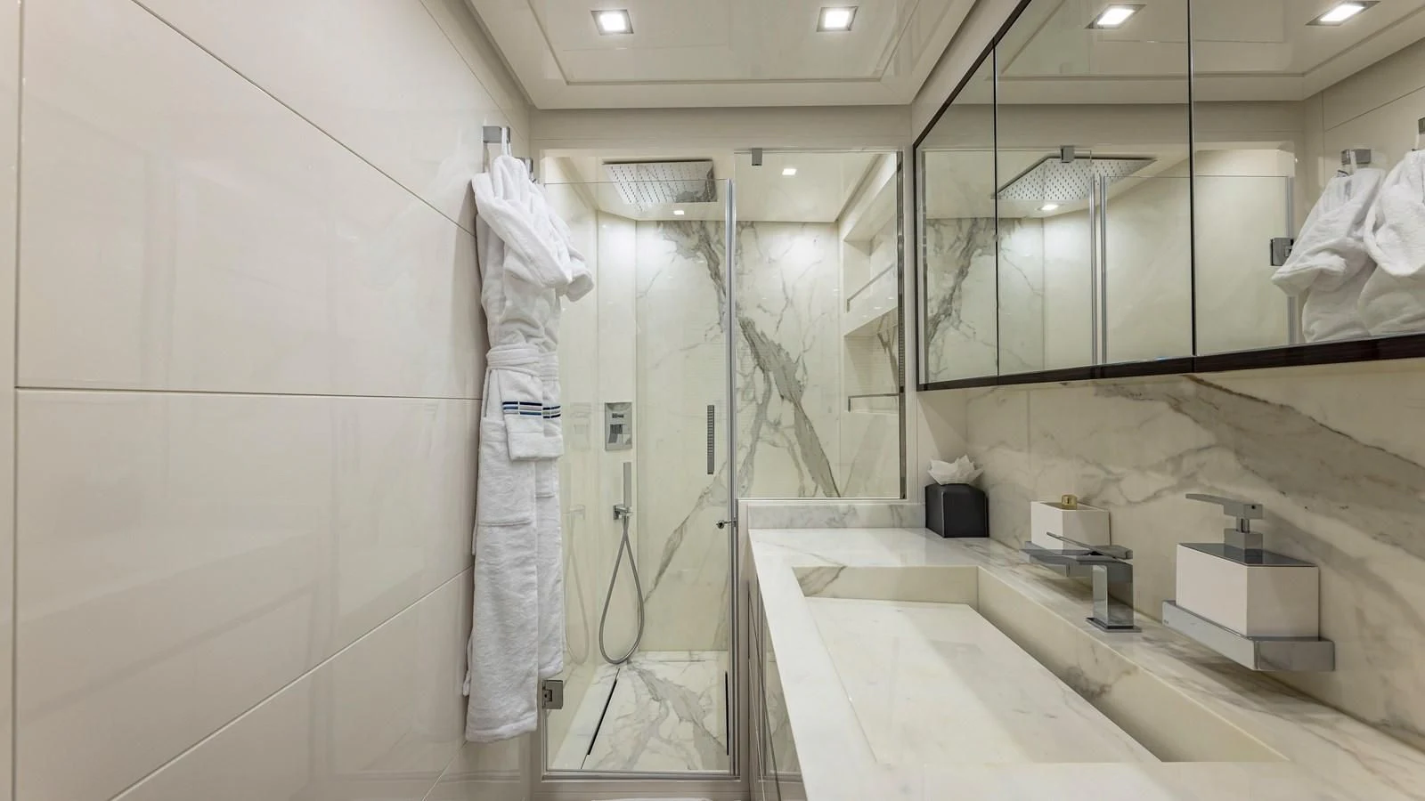 a bathroom with a robe on the wall aboard INCENTIVIZED Yacht for Sale