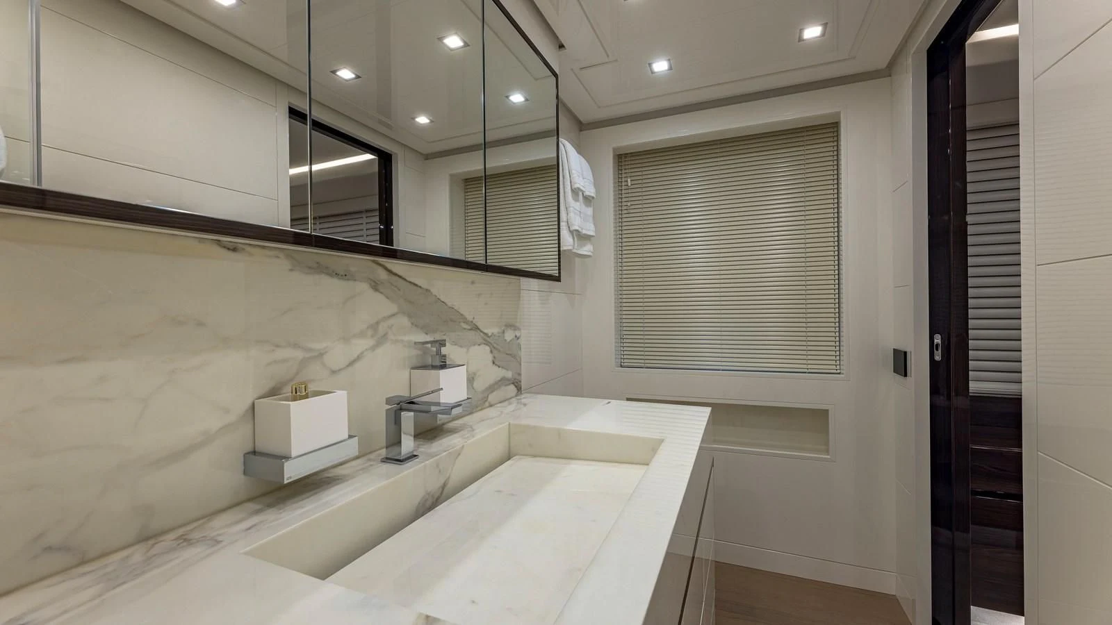 a bathroom with a bathtub and sinks aboard INCENTIVIZED Yacht for Sale