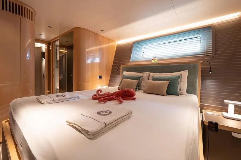a bed with a white sheet and pillows on it aboard KIA ORA Yacht for Sale
