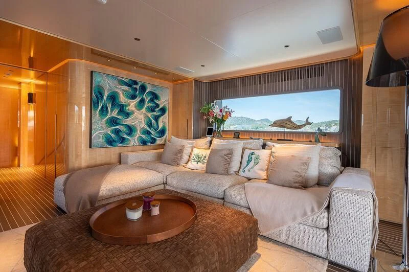 a living room with a large painting aboard KIA ORA Yacht for Sale