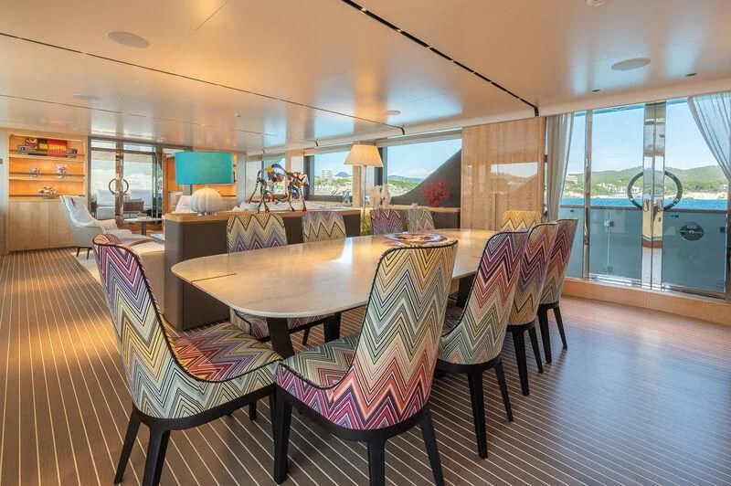 a large dining table in a room aboard KIA ORA Yacht for Sale