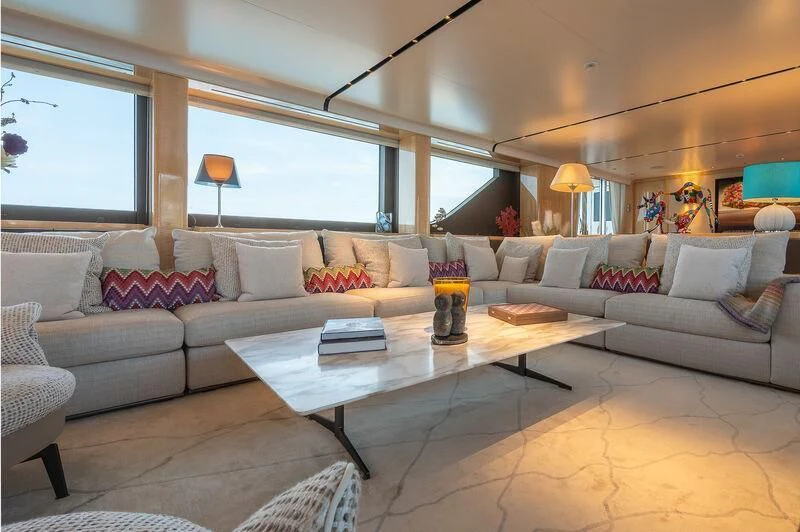 a living room with a couch and a coffee table aboard KIA ORA Yacht for Sale