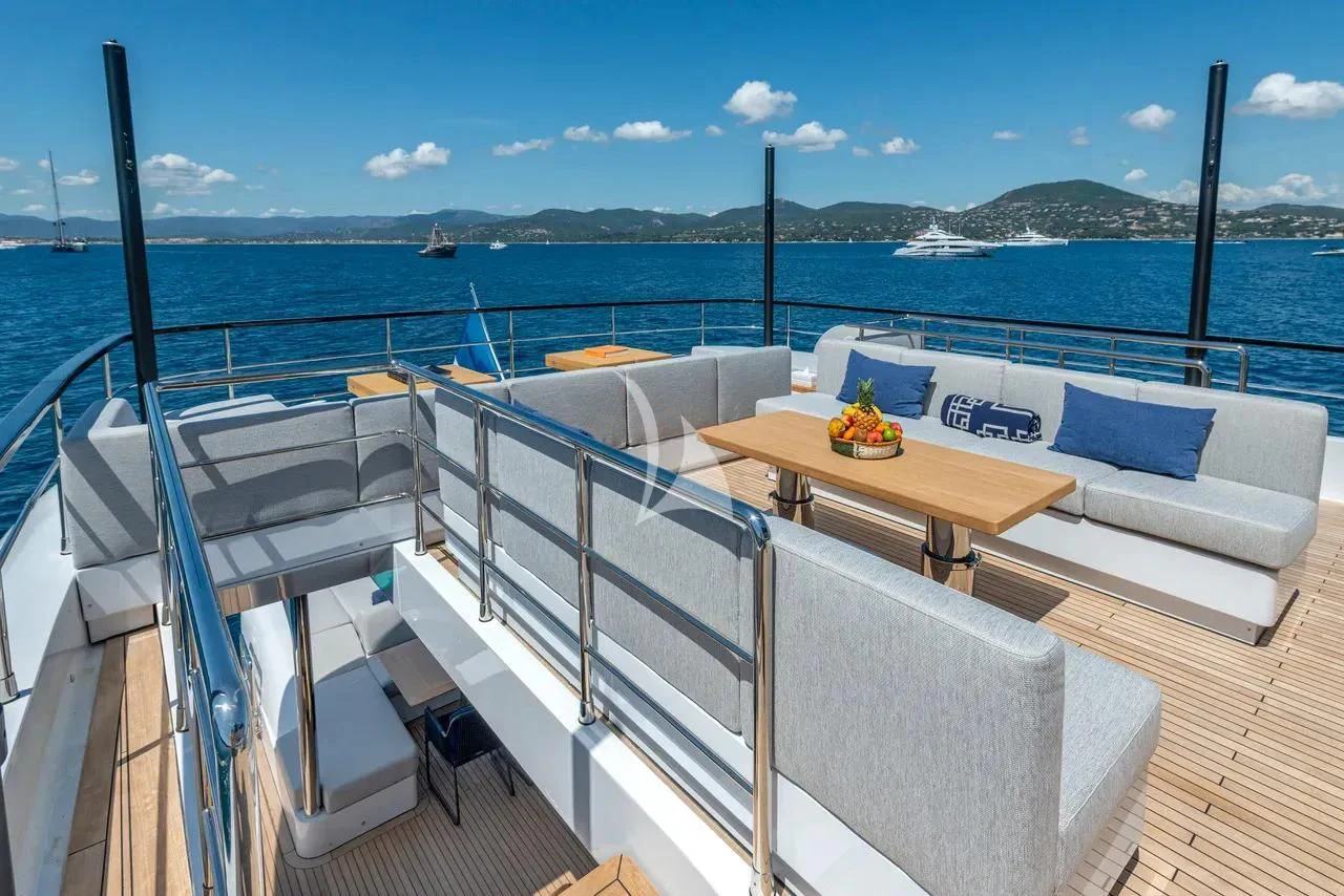 a deck with a table and chairs on it aboard ARSANA Yacht for Charter