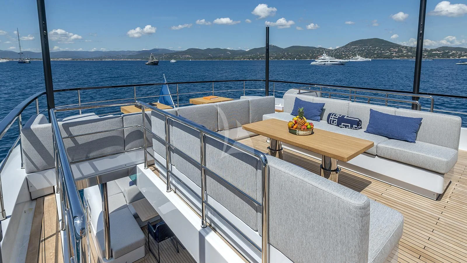 a balcony with a table and chairs aboard ARSANA Yacht for Charter