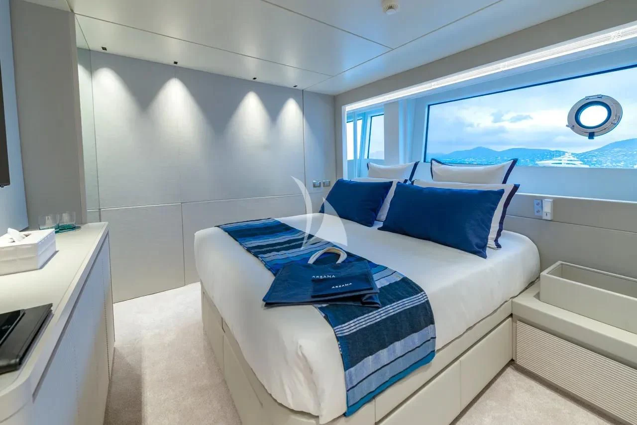 a room with a bed and a desk aboard ARSANA Yacht for Charter