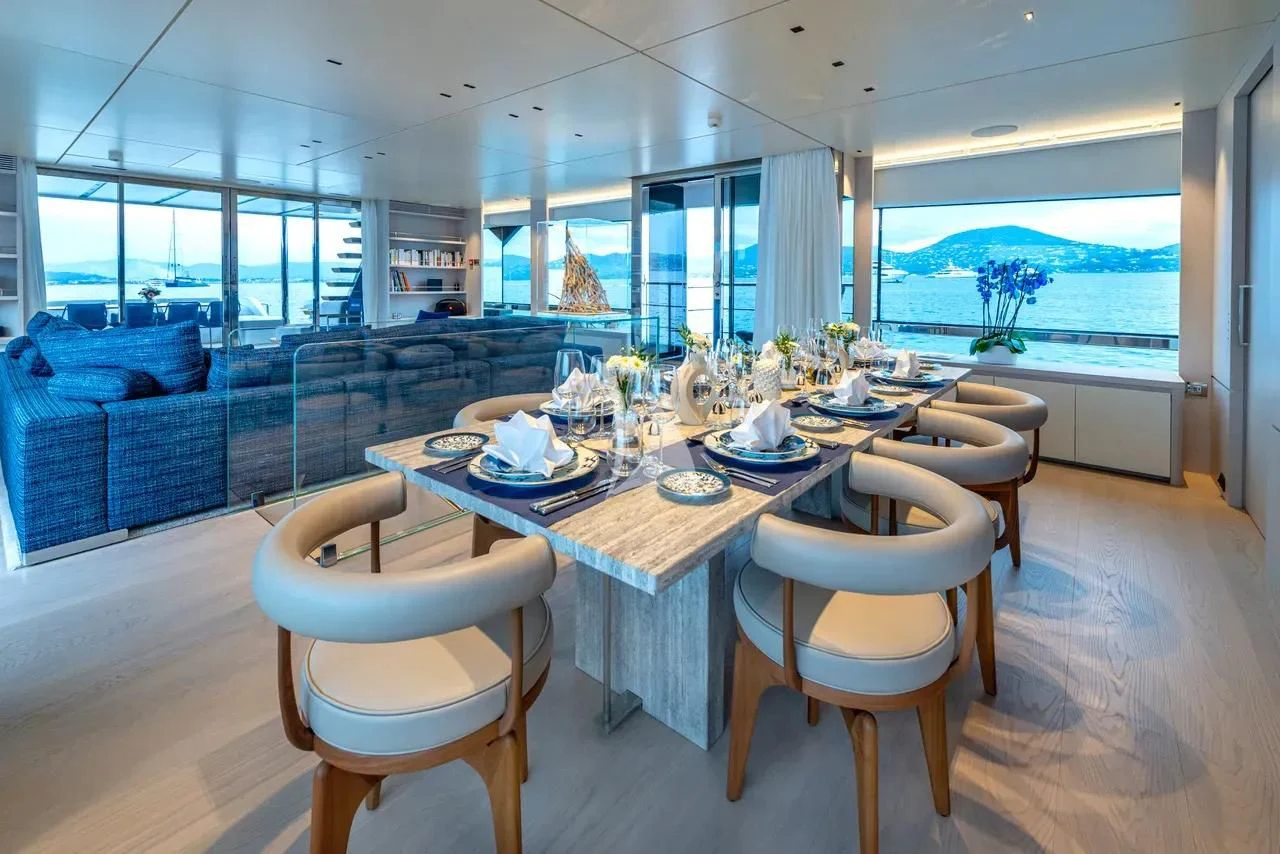a dining table in a living room aboard ARSANA Yacht for Charter