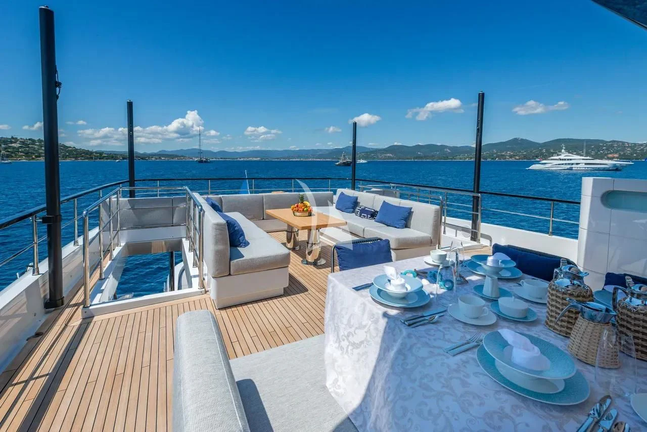 a balcony with a table and chairs on it aboard ARSANA Yacht for Charter