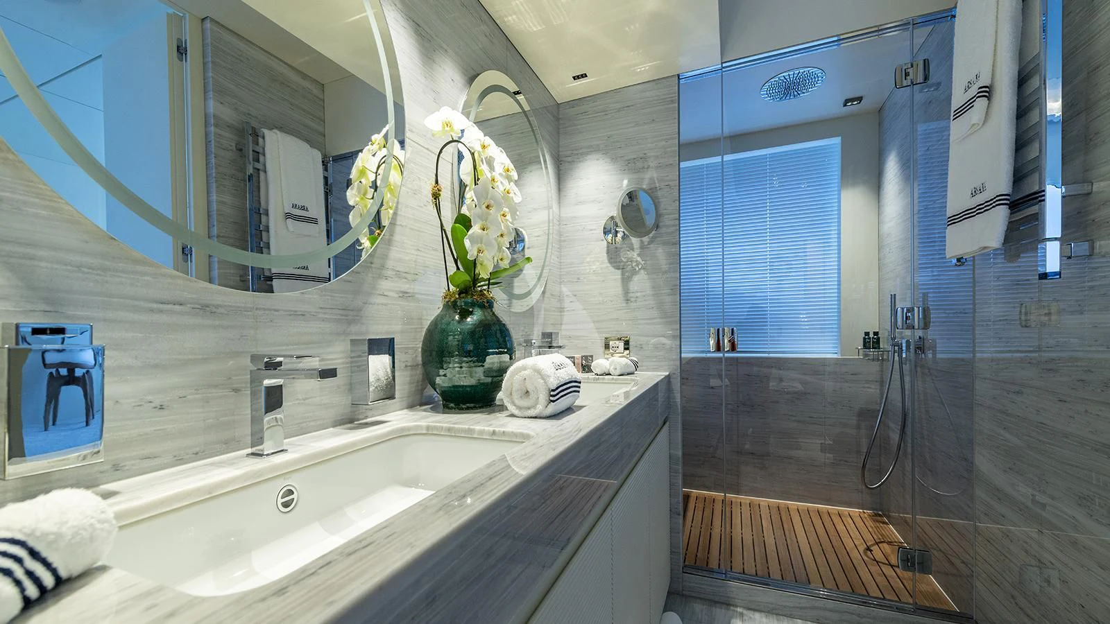a bathroom with a tub sink and mirror aboard ARSANA Yacht for Charter