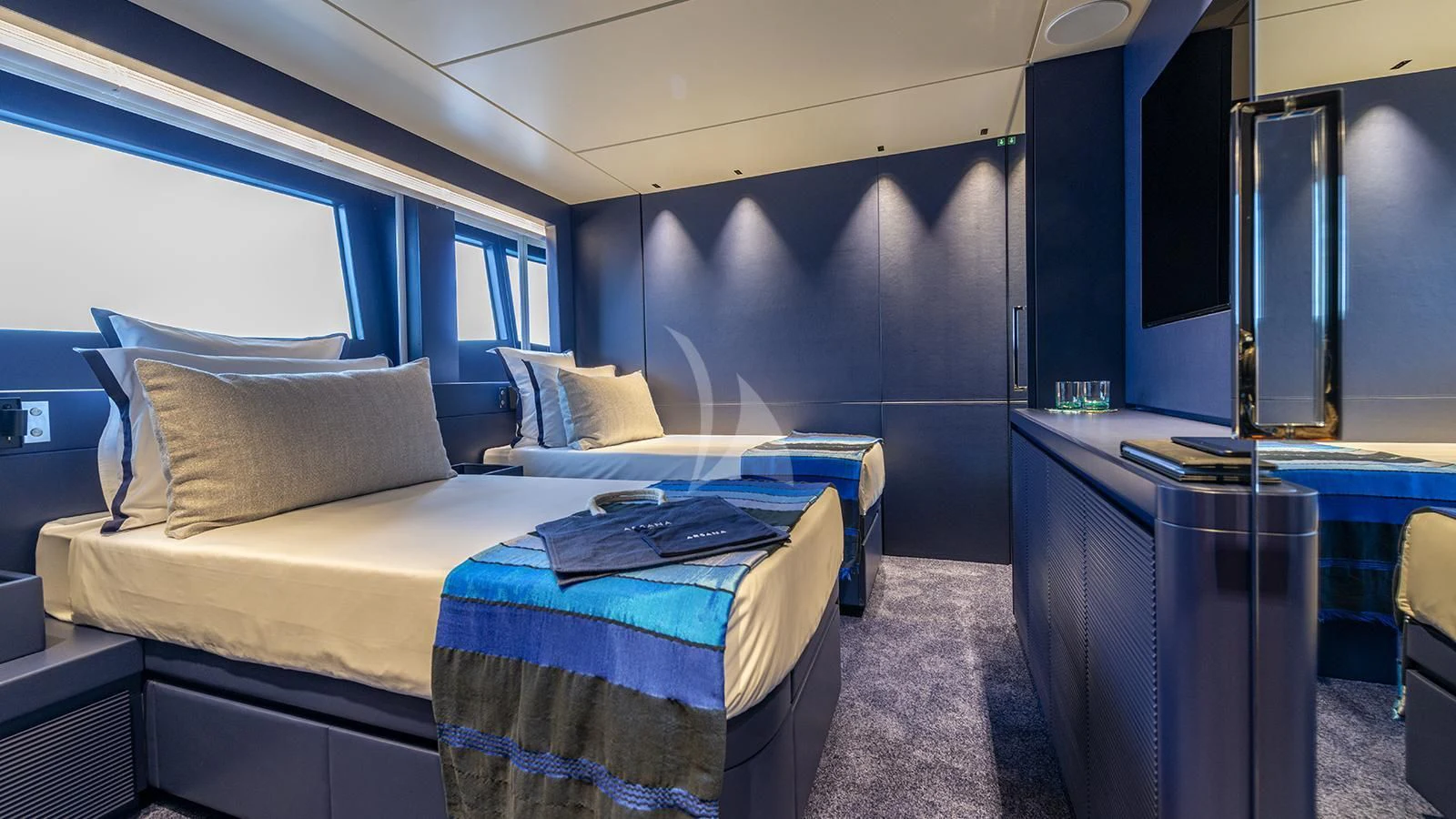 a room with a bed and desk aboard ARSANA Yacht for Charter