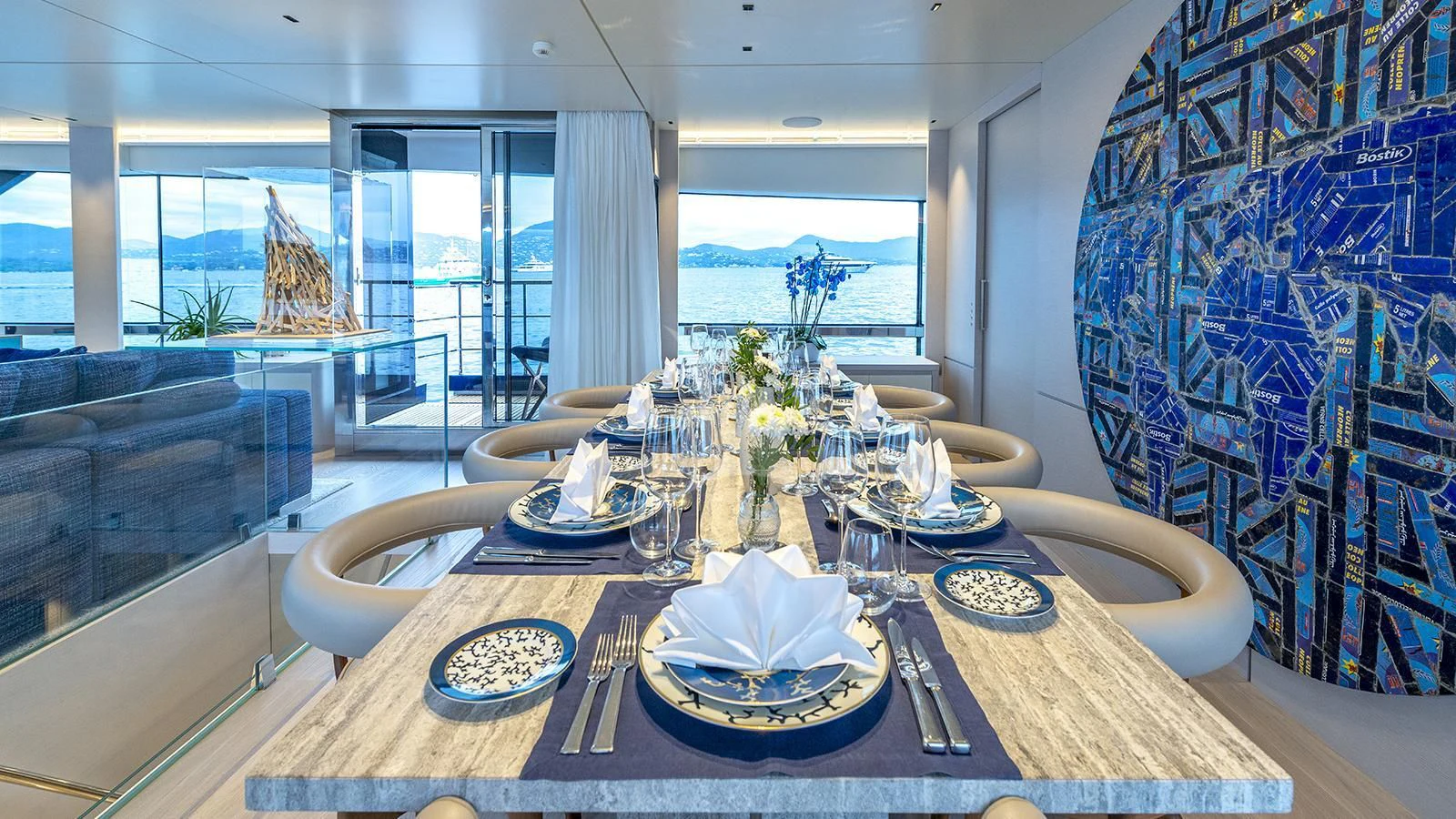a dining table with plates and silverware on it aboard ARSANA Yacht for Charter