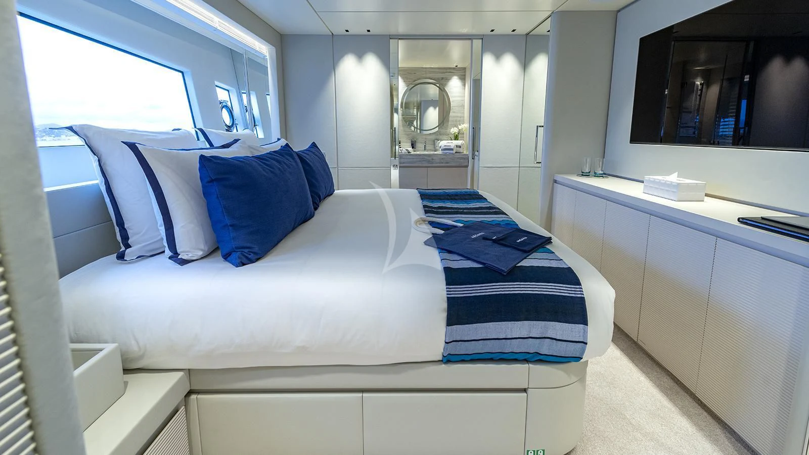 a bed with blue pillows aboard ARSANA Yacht for Charter
