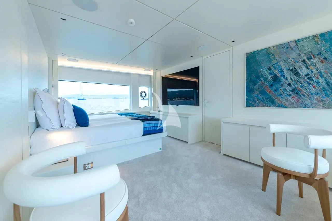 a room with a bed and a television aboard ARSANA Yacht for Charter