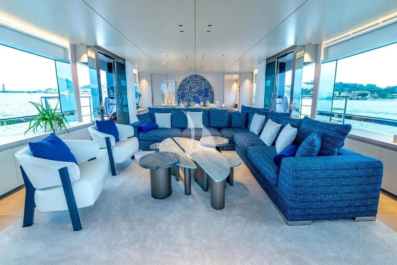 a room with blue couches aboard ARSANA Yacht for Charter