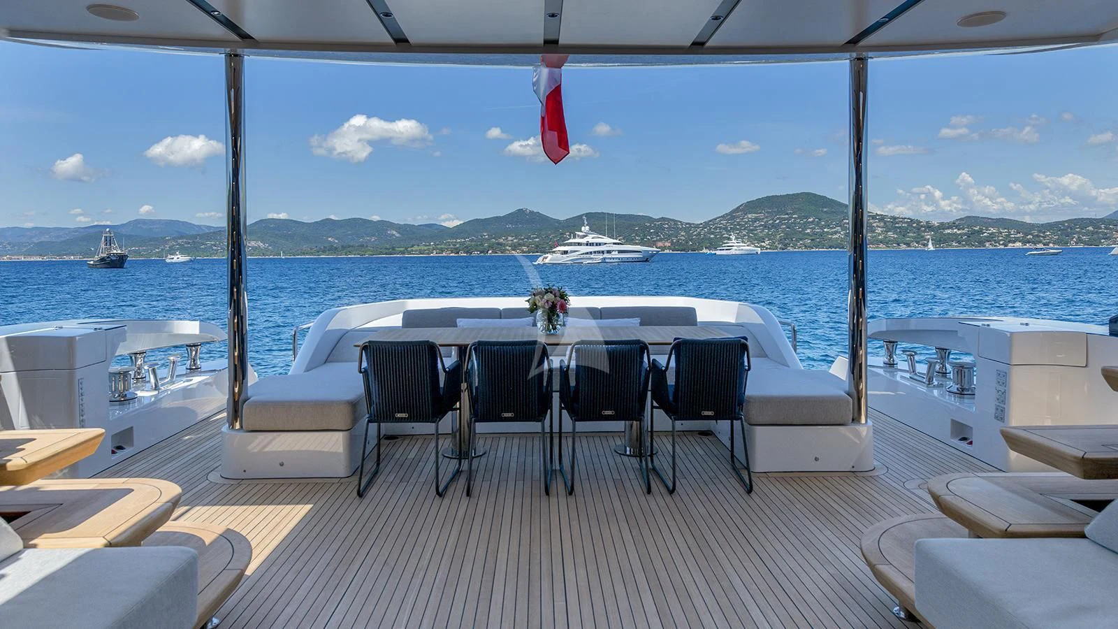 a deck with chairs and tables on it by the water aboard ARSANA Yacht for Charter