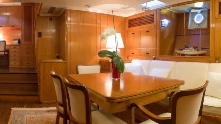 a dining room with a table and chairs aboard FEI-SEEN Yacht for Sale