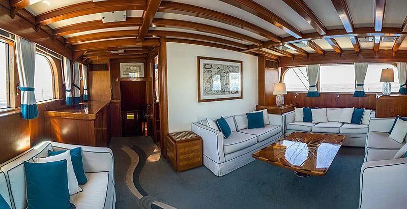 a living room with a couch and a table aboard FEI-SEEN Yacht for Sale