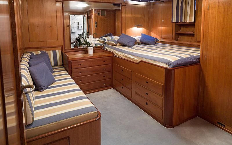 a room with a bed and a dresser aboard FEI-SEEN Yacht for Sale
