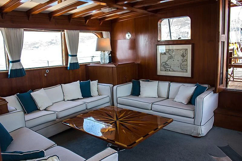 a living room with a couch and a coffee table aboard FEI-SEEN Yacht for Sale