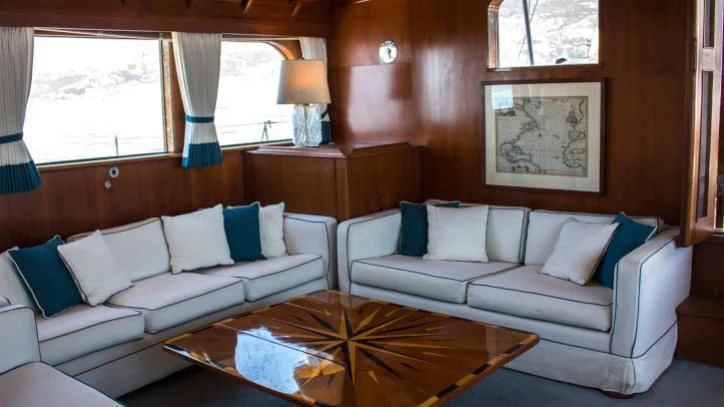 a living room with a couch and a coffee table aboard FEI-SEEN Yacht for Sale