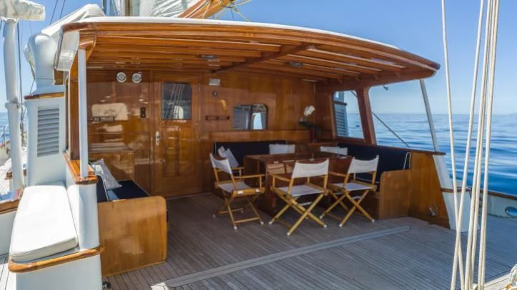 a boat with a table and chairs aboard FEI-SEEN Yacht for Sale