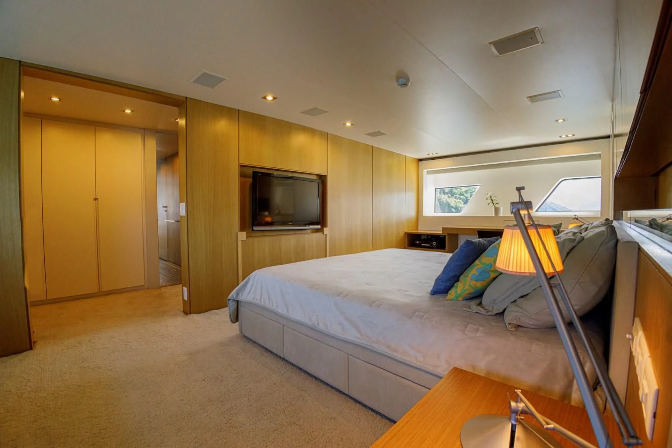 a bedroom with a bed and a desk aboard PAPA-GOLFE Yacht for Sale