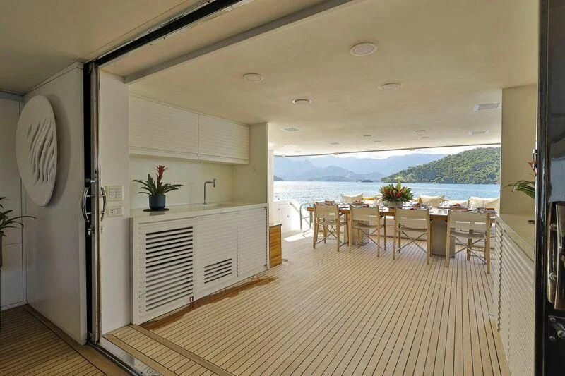 a large white room with a table and chairs aboard PAPA-GOLFE Yacht for Sale