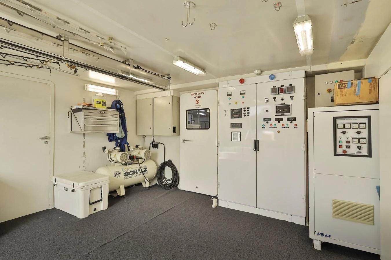 a room with white doors and a cart with a bike on it aboard PAPA-GOLFE Yacht for Sale