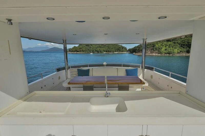 a pool with a table and chairs aboard PAPA-GOLFE Yacht for Sale