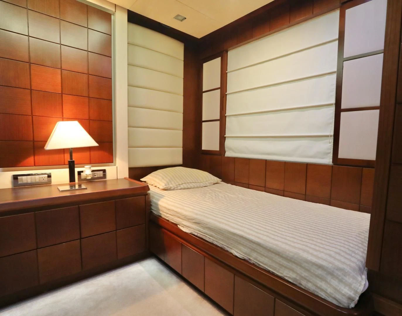 a room with a bed and a lamp aboard ANDREIKA Yacht for Sale