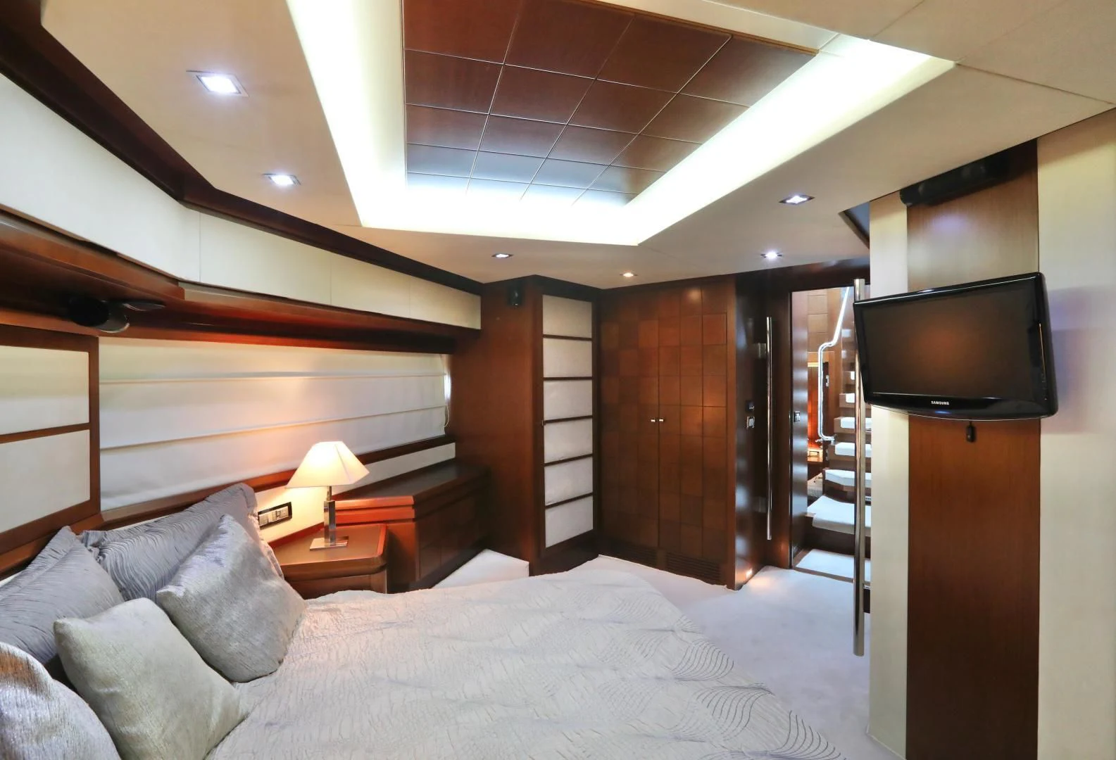 a bedroom with a bed and a television aboard ANDREIKA Yacht for Sale