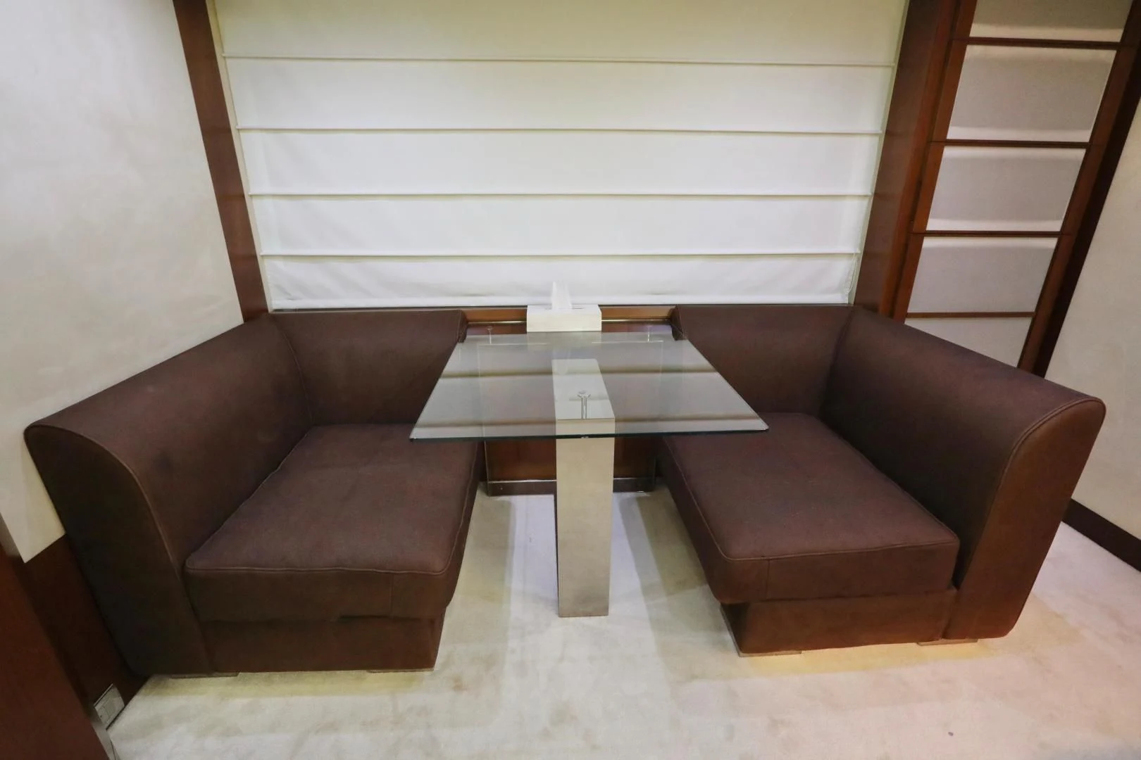 a couple of brown leather chairs next to a coffee table aboard ANDREIKA Yacht for Sale